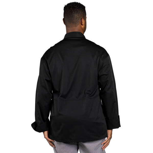 A man wearing a black Uncommon Chef long sleeve chef coat with a mesh back.