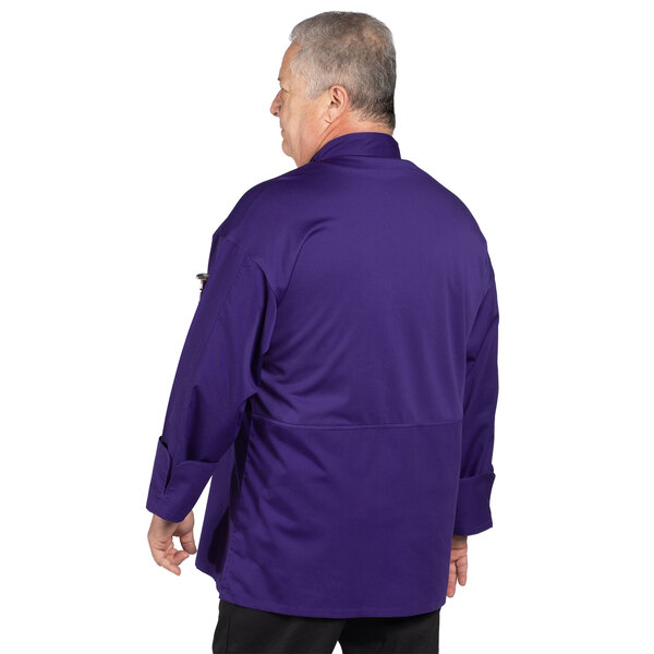 A man wearing a Uncommon Chef grape chef coat with a mesh back.