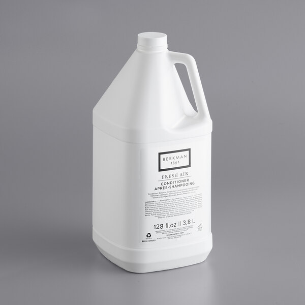 A white plastic jug of Beekman 1802 Fresh Air Conditioner with a white label and handle.