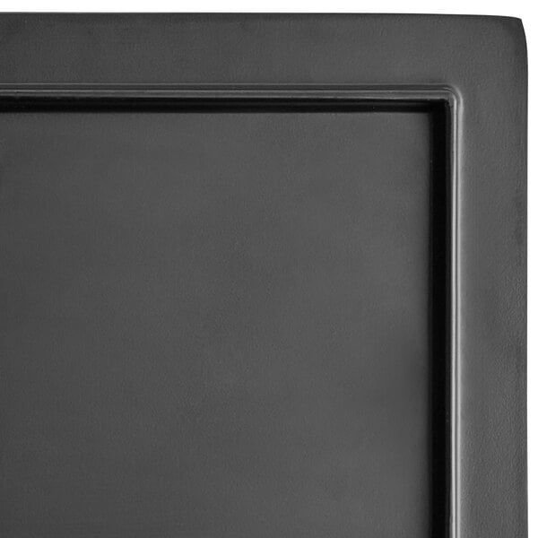 A black rectangular Acopa faux slate melamine footed serving board with corners.