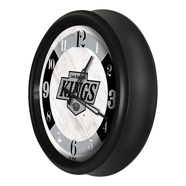 A round wall clock with a black frame featuring the Los Angeles Kings logo on the face.