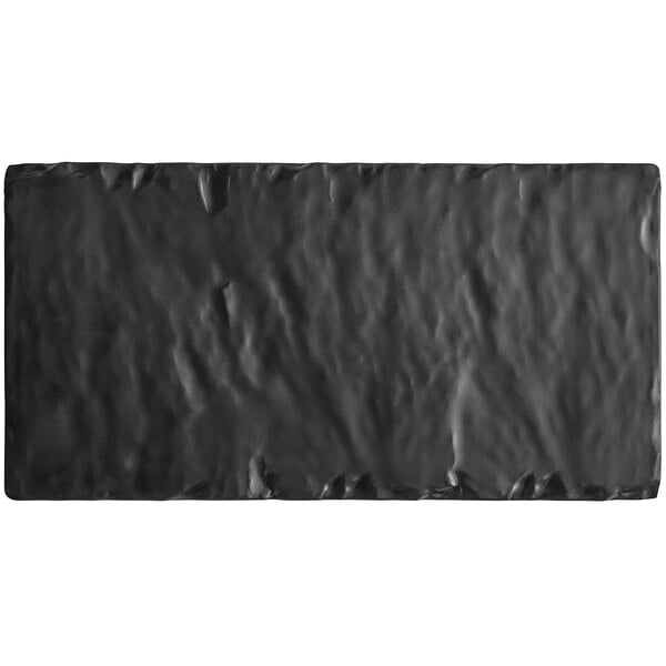 An Acopa black rectangular faux slate melamine serving board with a shiny surface.