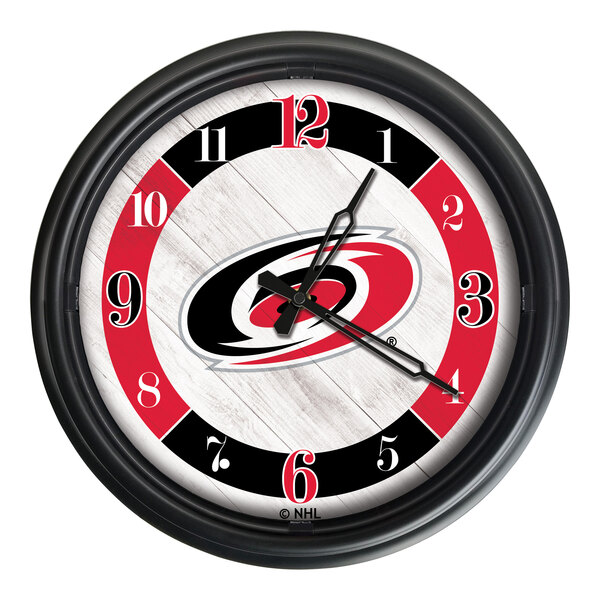 A Holland Bar Stool Carolina Hurricanes wall clock with LED lights.