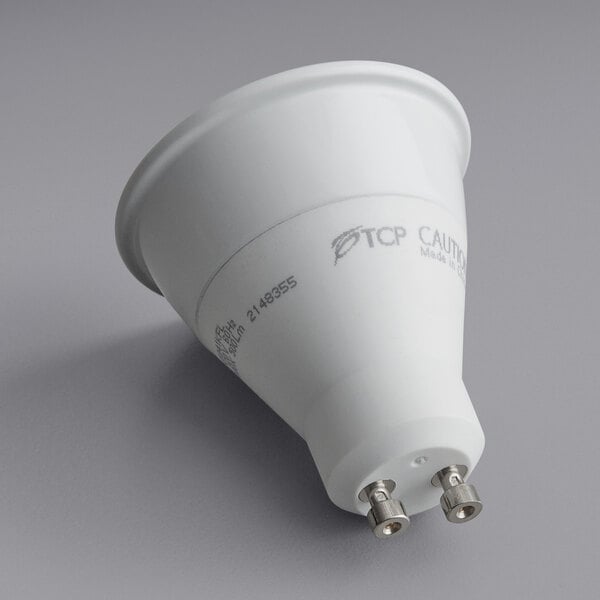 A TCP dimmable LED light bulb with a round base and silver connectors.