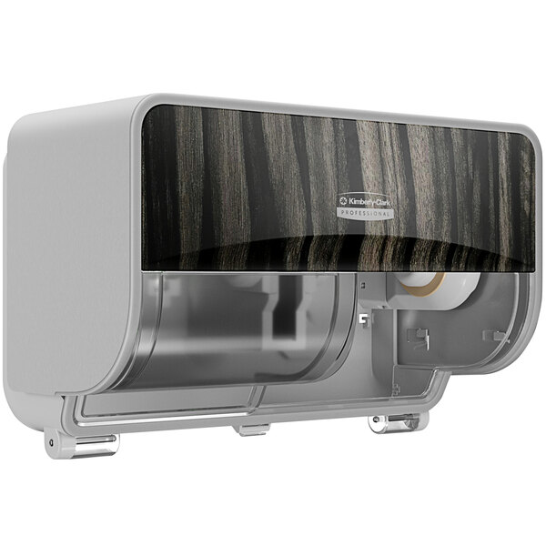 A silver and black toilet paper dispenser with a wood grain pattern.