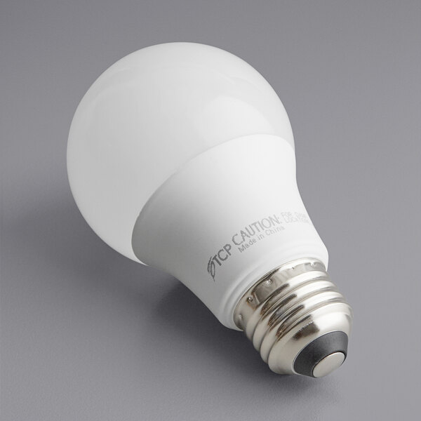 A TCP dimmable LED light bulb with a white label on a gray background.