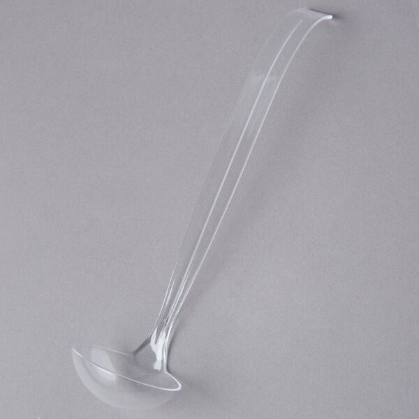 A clear plastic ladle with a handle.