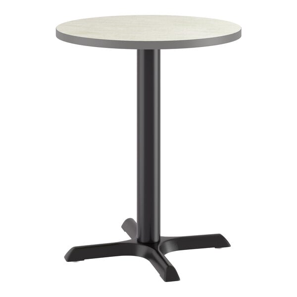 A round standard height table with a reversible gray or white laminated top and a black cast iron base.