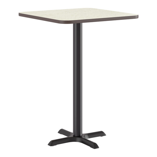 A square bar height table with a reversible white birch or ash laminated top and a black cast iron base.