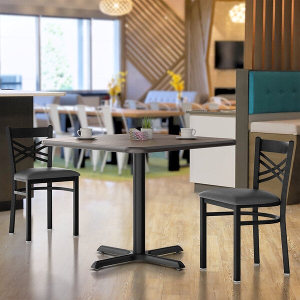 A Lancaster Table and Seating white table with a white cup on it.