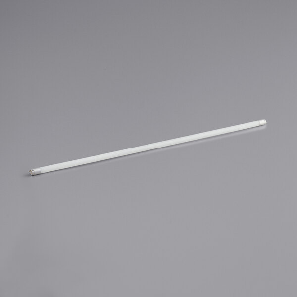 A TCP white LED tube light on a gray surface.