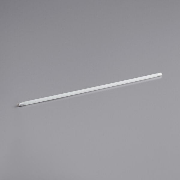 A TCP white LED tube light on a gray surface.