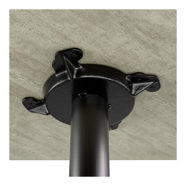 A standard height table with a reversible gray and white laminated top and a black cast iron base.