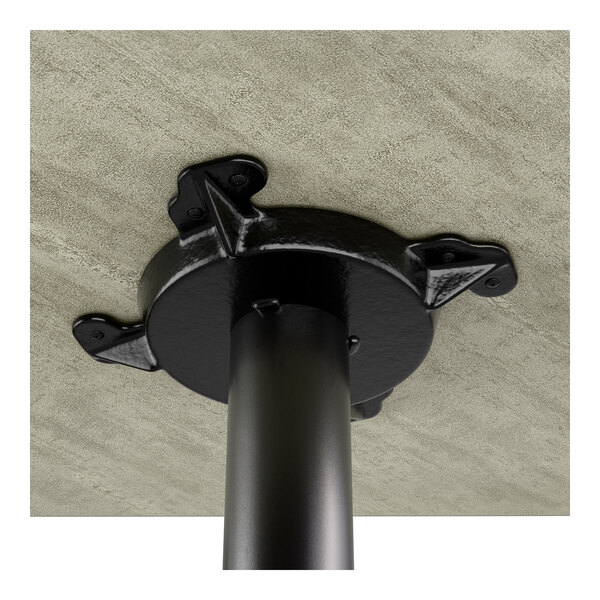 A bar height table with a reversible gray and white laminated top and a black cast iron base.