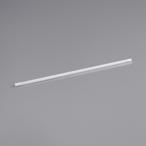 A white LED tube on a gray surface.