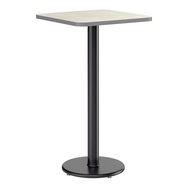 A square bar height table with a reversible gray and white laminated top and a black cast iron base.