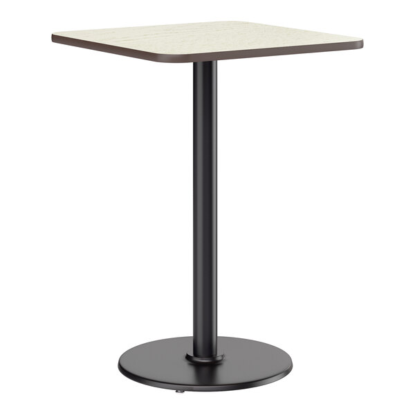 A square bar height table with a reversible white birch or ash laminated top and a black cast iron pedestal base.