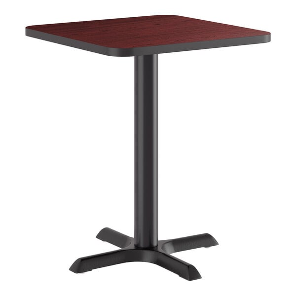 A square standard height table with a reversible cherry and black laminated top and a black cast iron base.