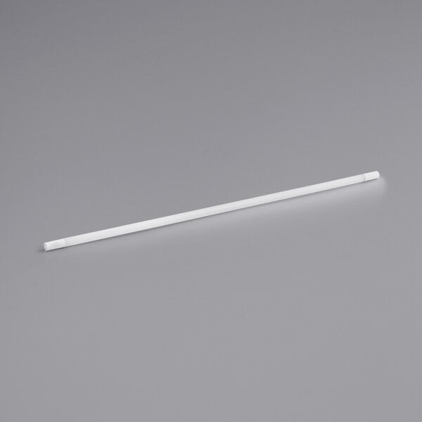 A white long LED tube with white plastic ends on a gray surface.