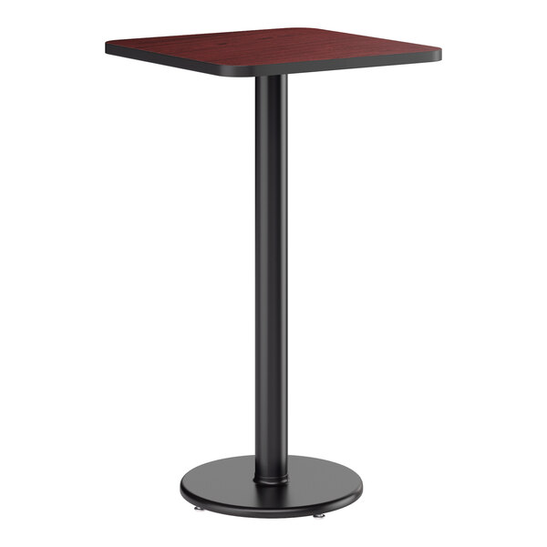 A square bar height table with a reversible cherry and black laminated top and a round cast iron base.