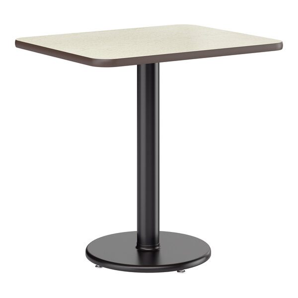 A rectangular table with a light wood-colored laminated top and a black metal pedestal base.