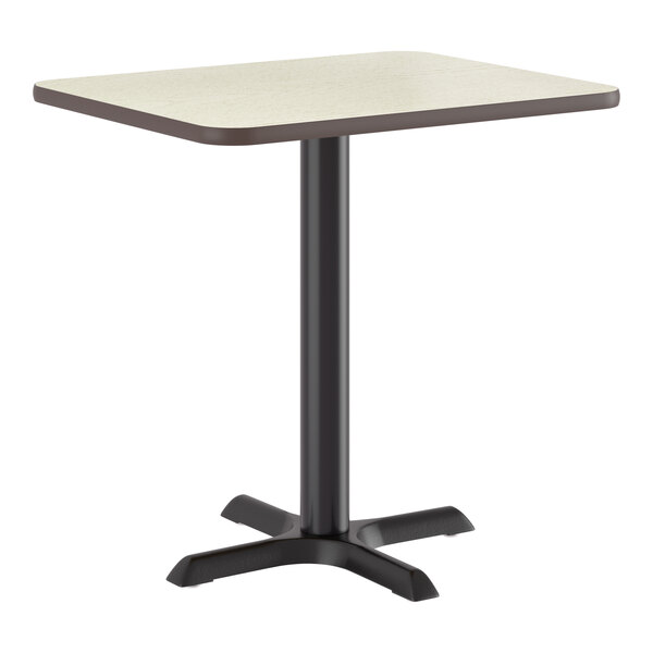 A rectangular standard height table with a reversible white birch or ash laminated top and a black cast iron base.