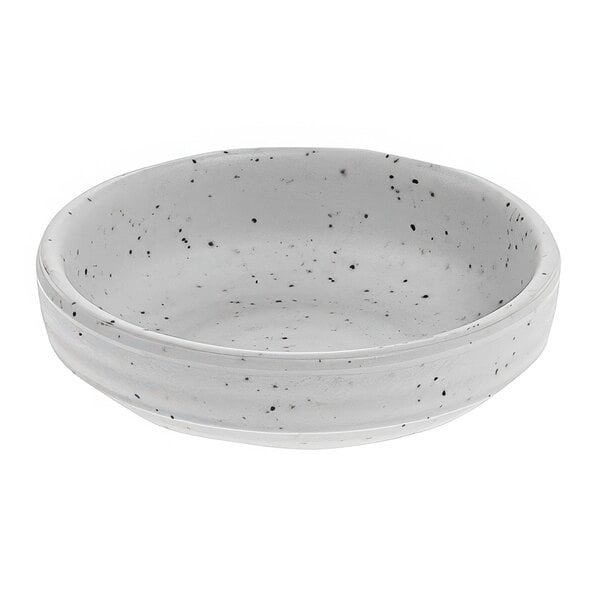 A white cheforward by GET round stone ramekin with black specks.