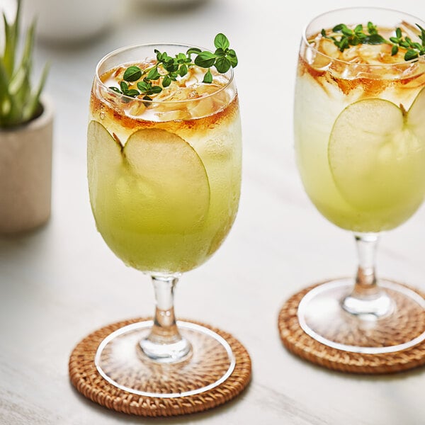 Two glasses of Les Vergers Boiron green apple fruit puree with garnish.