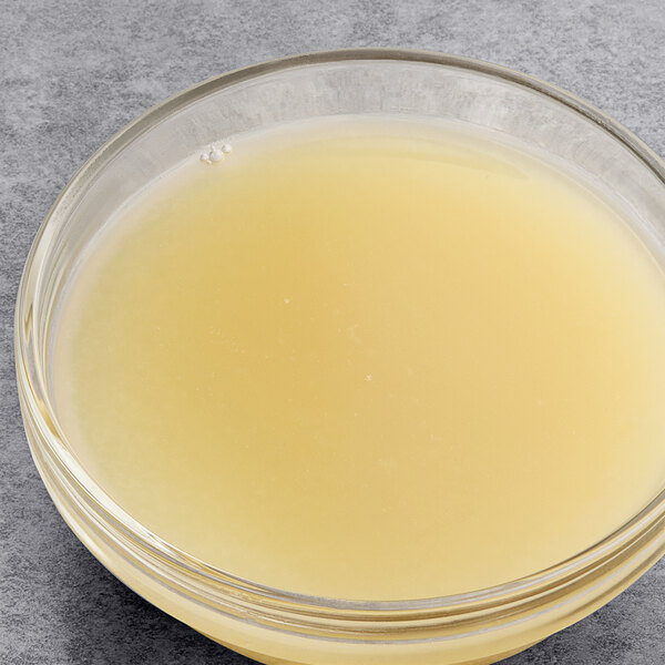 A bowl of Les Vergers Boiron lime fruit puree on a table.
