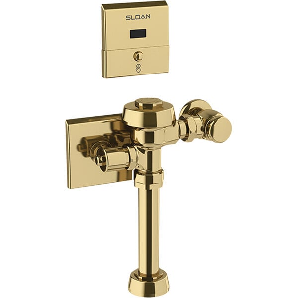 A gold metal Sloan water closet flushometer with a digital device.