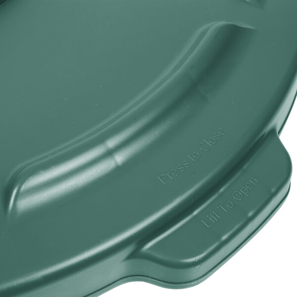 A green Rubbermaid Brute lid for a 55 gallon trash can.