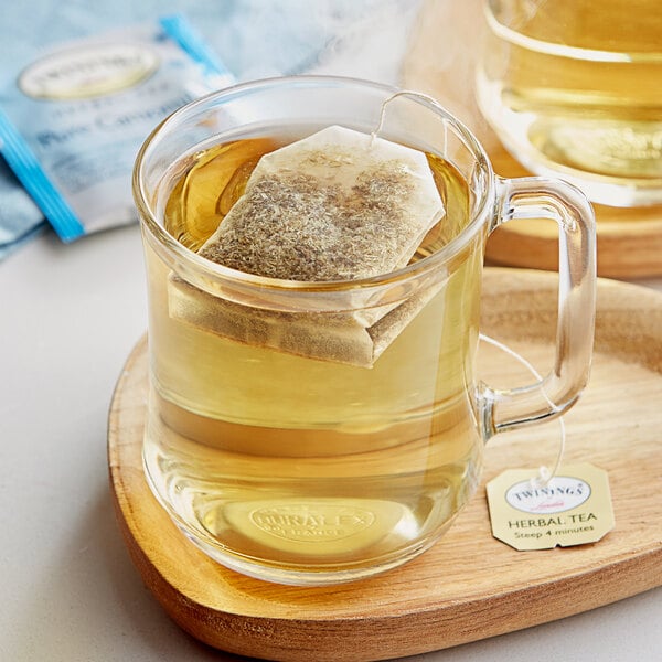 A glass mug of Twinings Pure Chamomile Tea with a tea bag in it.