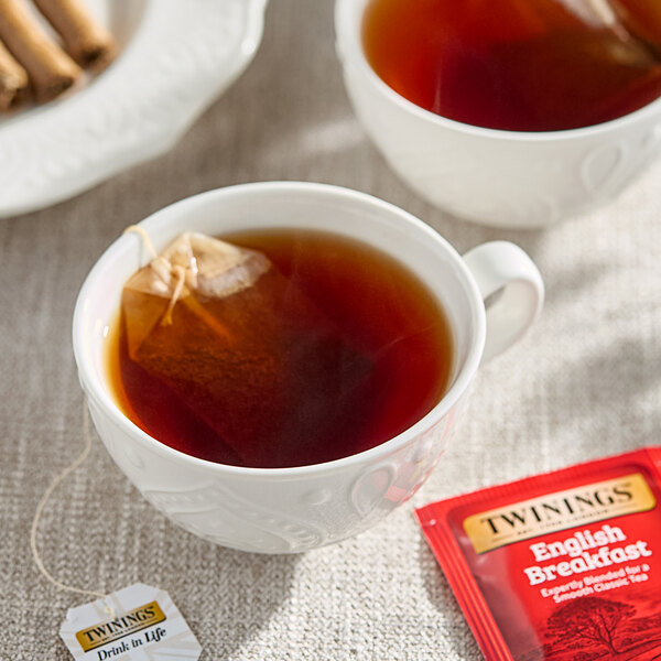 A cup of Twinings English Breakfast Tea with a tea bag in it.