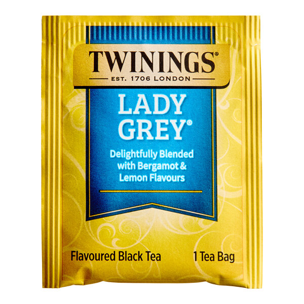 A yellow and blue box of Twinings Lady Grey tea bags.