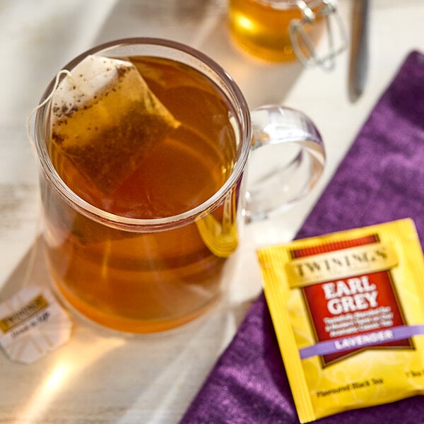 A glass cup of Twinings Earl Grey with Lavender tea with a tea bag in it.