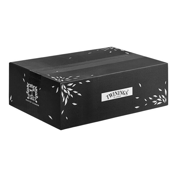 A black Twinings box with white text and white leaves.