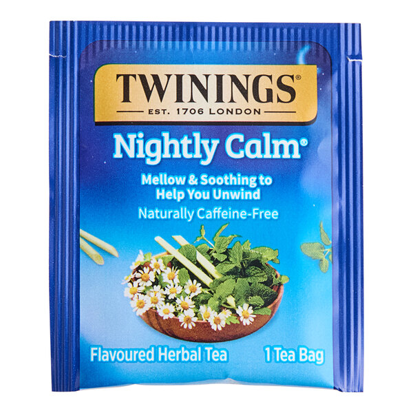 A blue box of Twinings Nightly Calm Herbal Tea Bags with a bowl of flowers and leaves on the label.