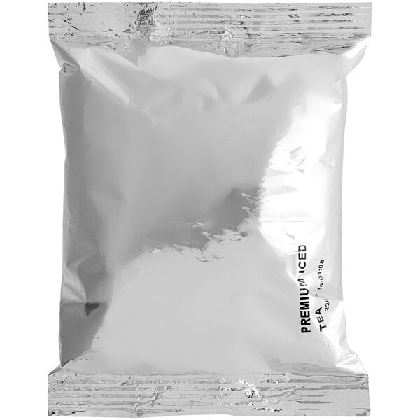 A silver Twinings bag of black powdered tea on a white background.