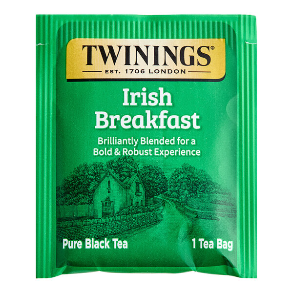 A green Twinings Irish Breakfast Tea bag with a drawing of a house and a road.