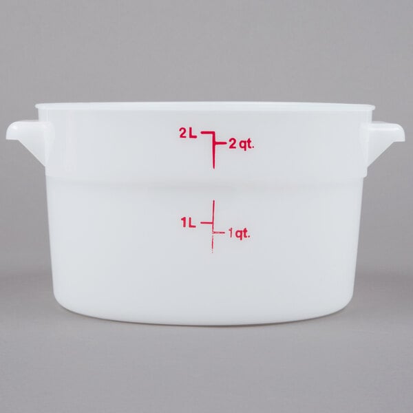 A white plastic container with red measurements and text.