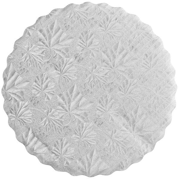 A white round Enjay cake circle with a pattern of leaves.