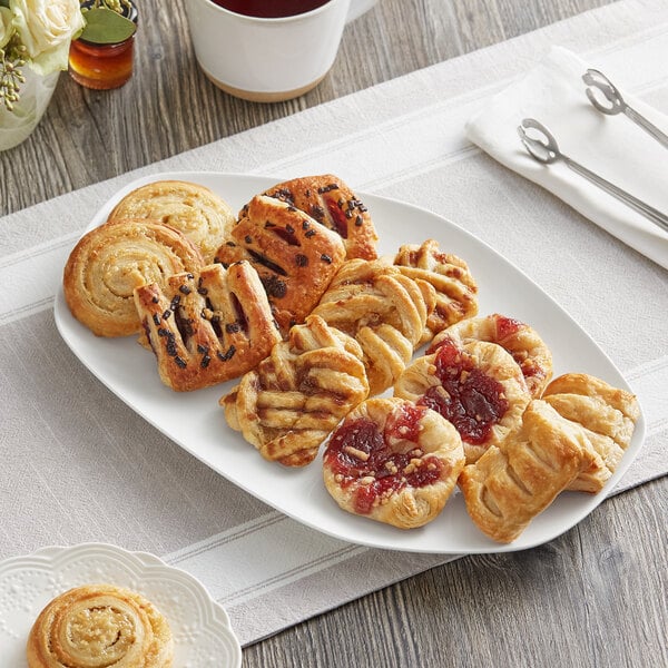 A plate of Schulstad Ready to Bake Mini Assorted Danish pastries on a table.