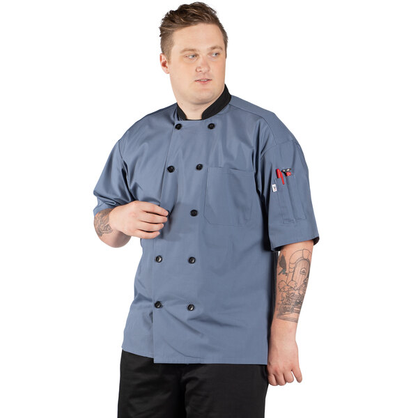 A man wearing a Uncommon Chef Havana short sleeve chef coat with mesh back.