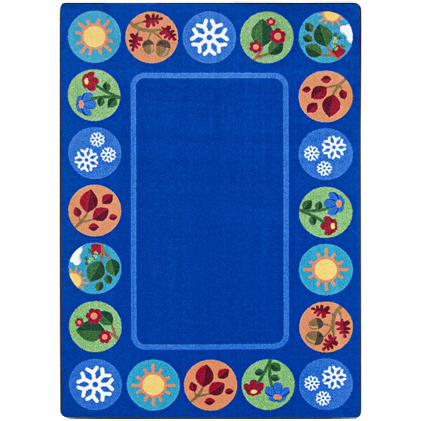 A blue rectangular rug with white lines and colorful circles and flowers.