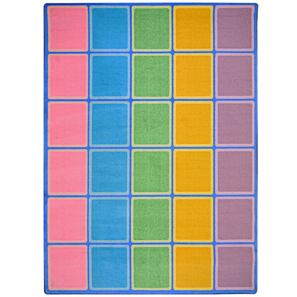 A pastel area rug with colorful squares in blue, green, yellow, and pink.