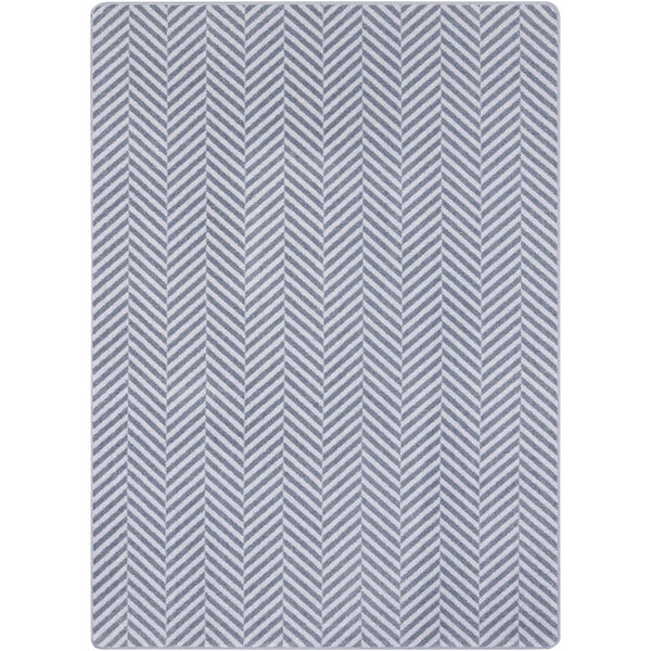 A white rectangular area rug with a gray chevron pattern.