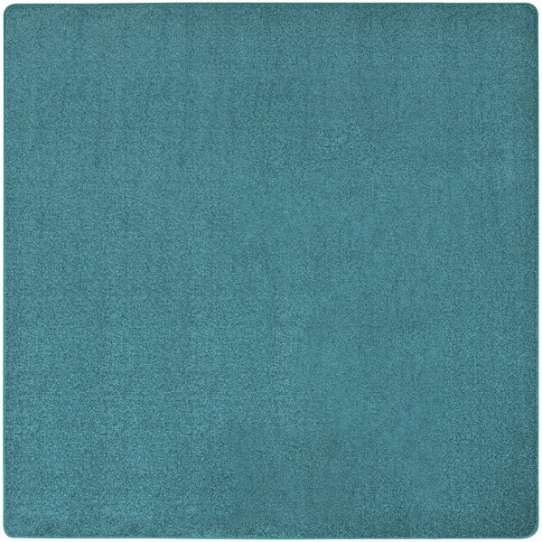 A mint square rug by Joy Carpets in a room.