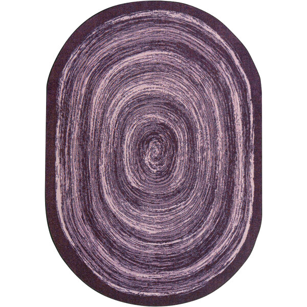 A close-up of a purple Joy Carpets oval area rug with a circular design.