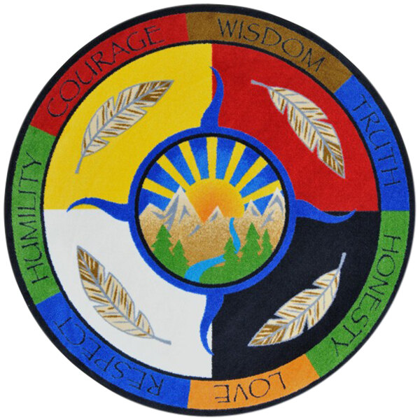 A multicolored circular area rug with the words "peace," "wisdom," and "harmony" in the center.