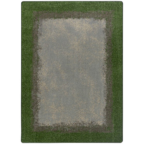 A Joy Carpets rectangular area rug with a white background and a green and gray rectangular border featuring a grassy meadow.